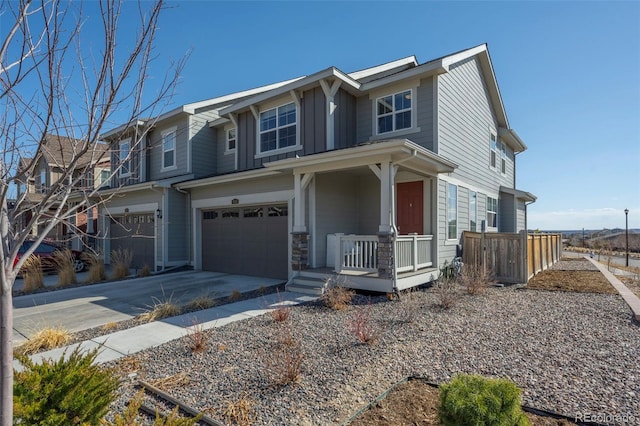 view of front of home featuring board and batten siding, fence, a porch, concrete driveway, and a garage