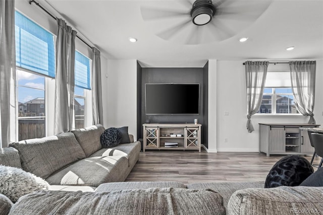 living area with ceiling fan, baseboards, wood finished floors, and recessed lighting