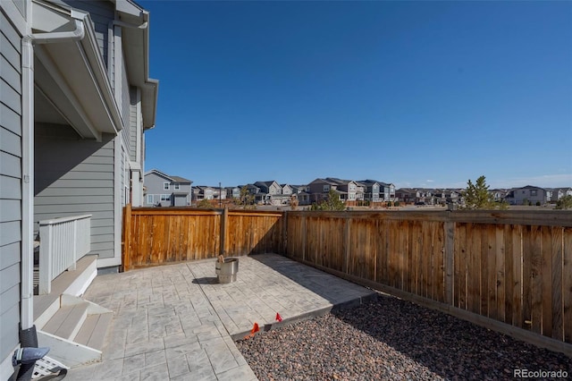 view of patio featuring a fenced backyard and a residential view