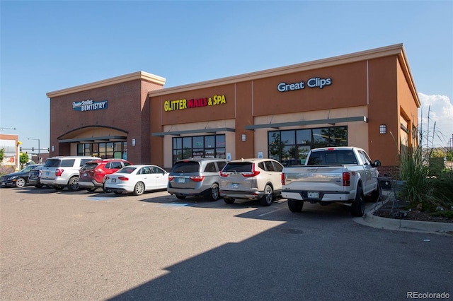 view of building exterior featuring uncovered parking