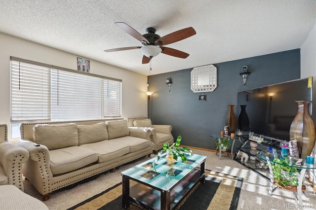 living room with plenty of natural light, ceiling fan, carpet floors, and a textured ceiling