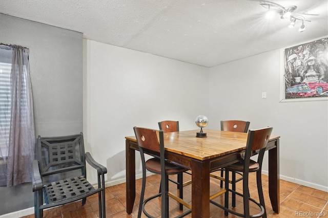 dining area with a textured ceiling