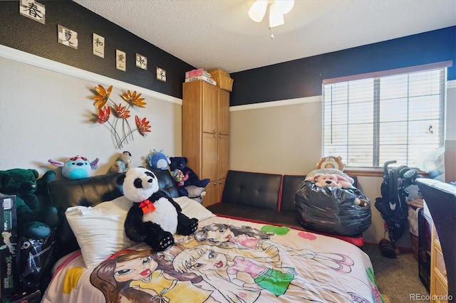 bedroom featuring carpet floors and a textured ceiling