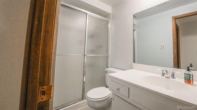 bathroom with toilet, an enclosed shower, and vanity