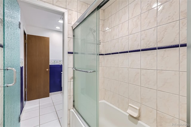 bathroom featuring tile patterned floors, enclosed tub / shower combo, and tile walls