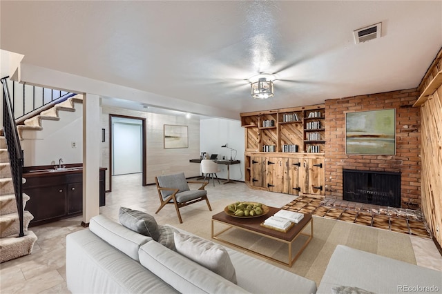 living room featuring sink and a fireplace