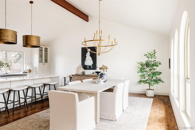 dining room with a notable chandelier, lofted ceiling with beams, baseboards, and wood finished floors