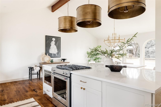 kitchen featuring dark wood-style flooring, vaulted ceiling with beams, stainless steel range, light countertops, and white cabinetry