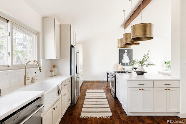 kitchen featuring dark wood-style floors, light countertops, appliances with stainless steel finishes, and white cabinets