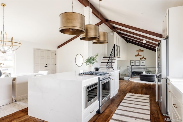 kitchen featuring lofted ceiling with beams, appliances with stainless steel finishes, dark wood finished floors, and white cabinets