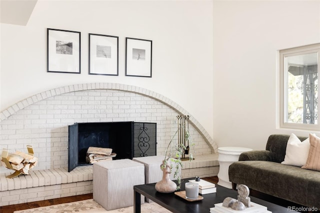 living area with a fireplace and wood finished floors