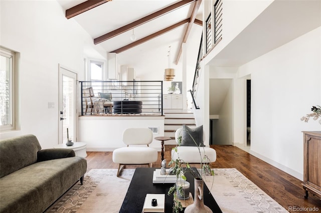 living room featuring stairs, high vaulted ceiling, wood finished floors, and beamed ceiling