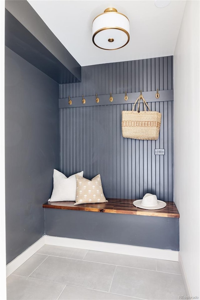 mudroom with baseboards and tile patterned floors