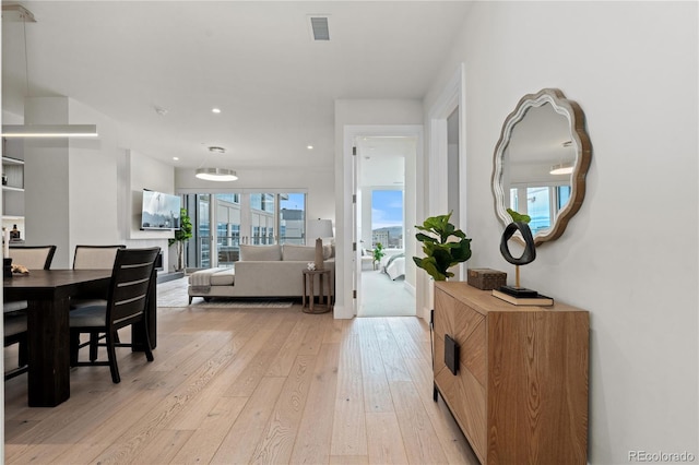 interior space featuring light wood-style flooring, visible vents, and recessed lighting