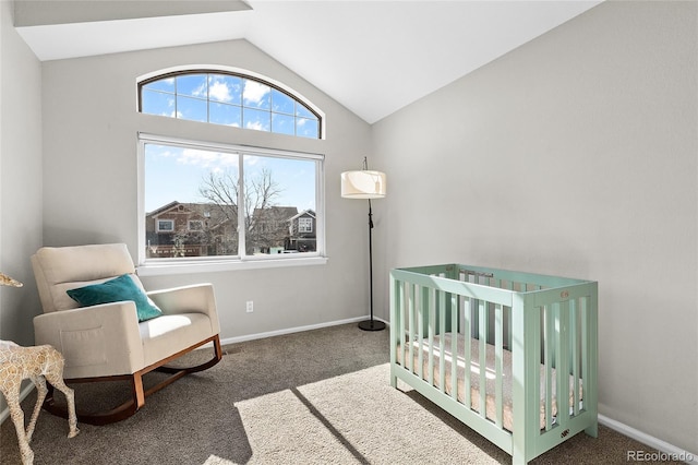 carpeted bedroom featuring lofted ceiling, a crib, and baseboards