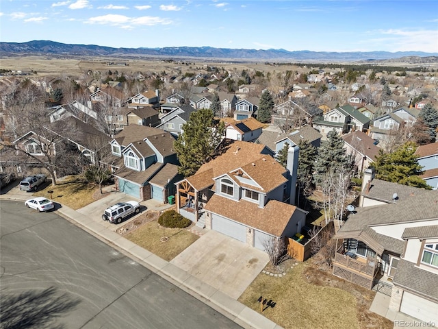 drone / aerial view featuring a residential view and a mountain view