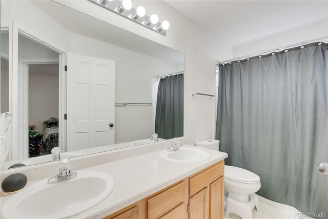 5149 S Genoa Ct, Centennial, CO 80015 - bathroom featuring toilet, double vanity, ensuite bath, and a shower with curtain