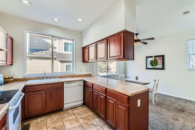 kitchen with ceiling fan, sink, kitchen peninsula, white appliances, and light tile patterned floors