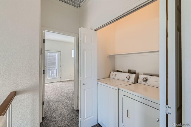 laundry area featuring washer and dryer and carpet flooring