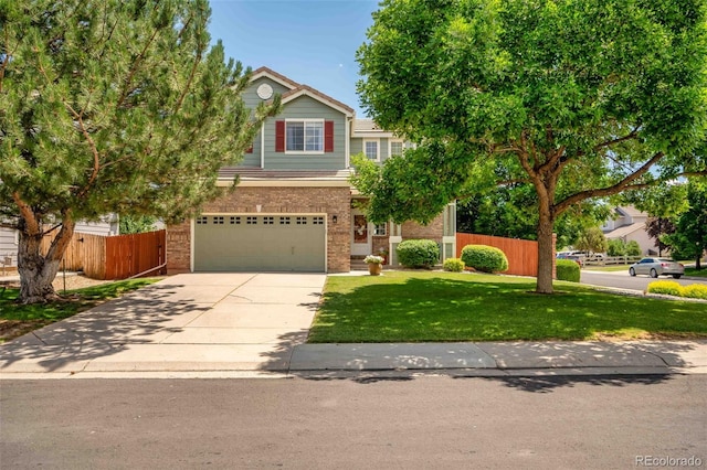2476 S Gibralter Way, Aurora, CO 80013 - view of front of house with brick siding, an attached garage, and driveway