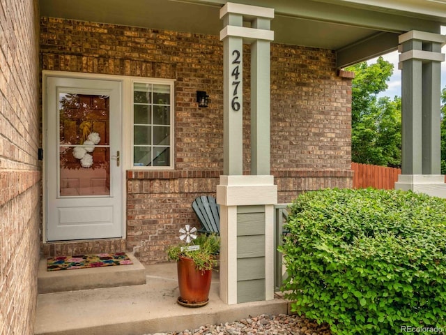2476 S Gibralter Way, Aurora, CO 80013 - entrance to property featuring a porch and brick siding