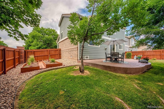 2476 S Gibralter Way, Aurora, CO 80013 - fenced backyard with a garden and a patio