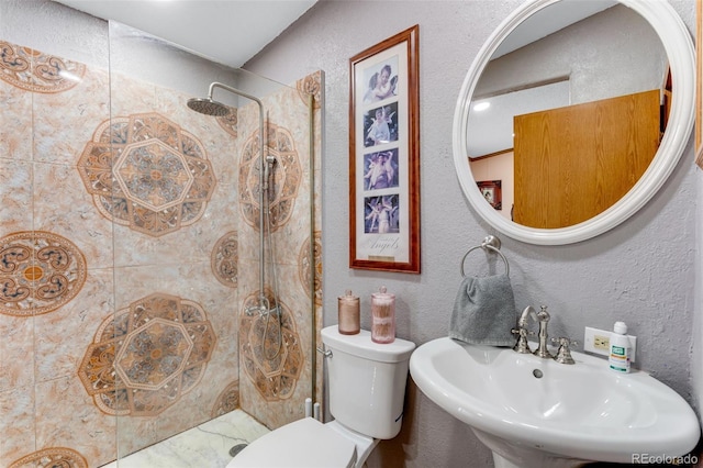 6310 W County Road 4, Berthoud, CO 80513 - bathroom featuring a sink, a tile shower, a textured wall, and toilet