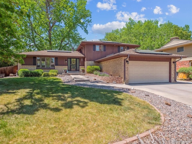 7379 S Lafayette Cir W, Centennial, CO 80122 - tri-level home with solar panels, an attached garage, a front lawn, and concrete driveway