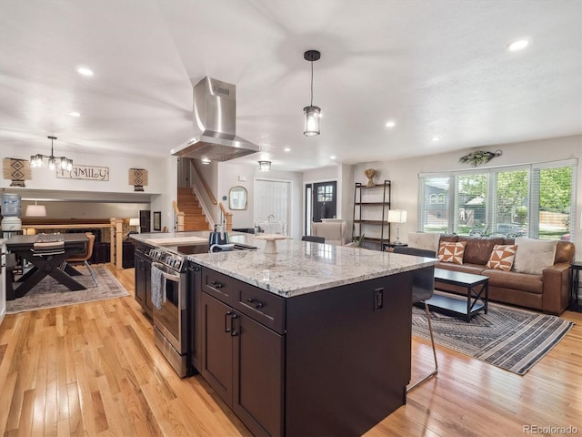 7379 S Lafayette Cir W, Centennial, CO 80122 - kitchen with stainless steel range with electric cooktop, open floor plan, island exhaust hood, light wood-style flooring, and pendant lighting