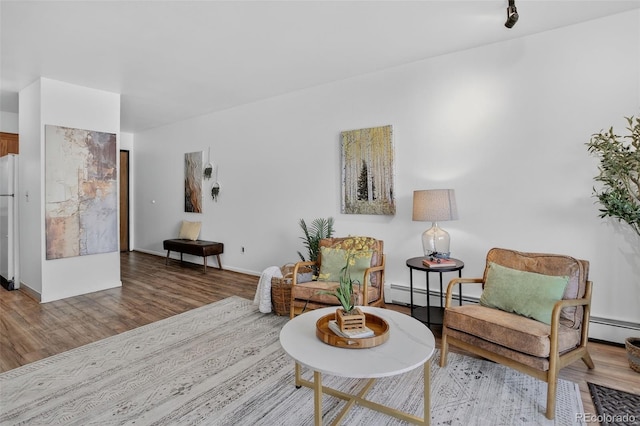 31270 John Wallace Rd Unit 302, Evergreen, CO 80439 - sitting room featuring a baseboard heating unit, wood finished floors, and a baseboard radiator
