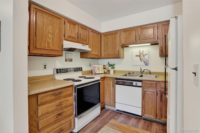31270 John Wallace Rd Unit 302, Evergreen, CO 80439 - kitchen featuring white appliances, under cabinet range hood, light countertops, and dark wood-type flooring