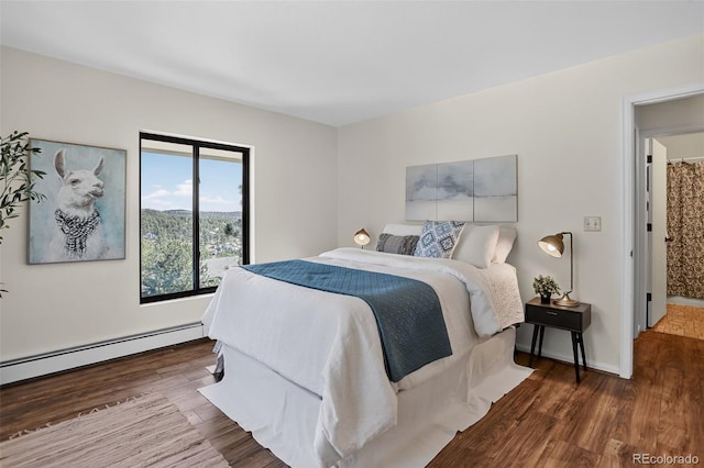 31270 John Wallace Rd Unit 302, Evergreen, CO 80439 - bedroom featuring a baseboard heating unit and wood finished floors
