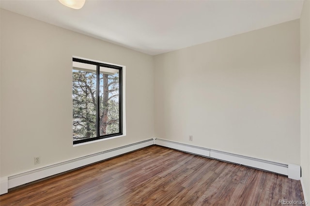 31270 John Wallace Rd Unit 302, Evergreen, CO 80439 - spare room with a baseboard heating unit, wood finished floors, and baseboard heating