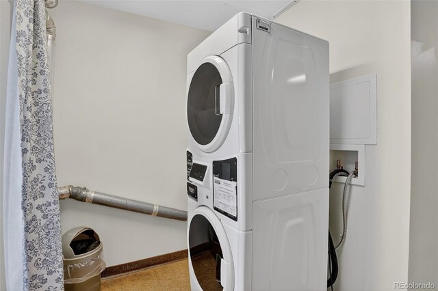 31270 John Wallace Rd Unit 302, Evergreen, CO 80439 - laundry room with stacked washer and clothes dryer and baseboards