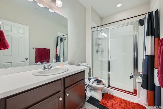 bathroom with visible vents, vanity, a shower stall, and toilet