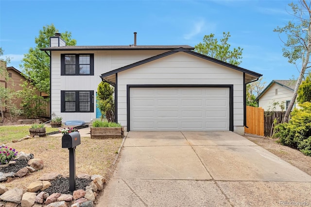 3575 S Ouray St, Aurora, CO 80013 - view of front of house with concrete driveway, a chimney, and a garage