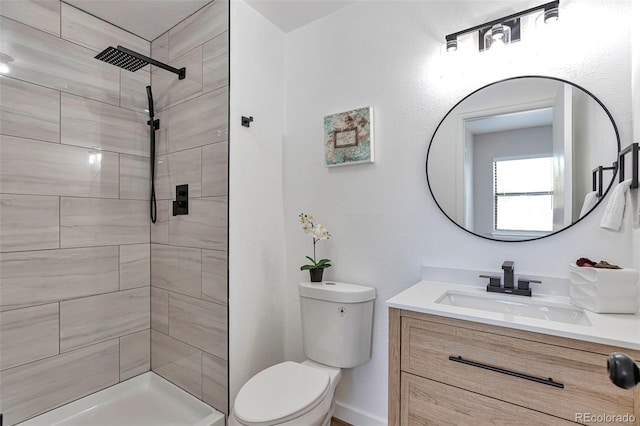 3575 S Ouray St, Aurora, CO 80013 - bathroom featuring vanity, toilet, and a tile shower