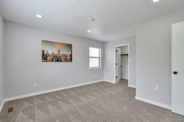3575 S Ouray St, Aurora, CO 80013 - unfurnished bedroom with carpet floors, recessed lighting, baseboards, and a walk in closet