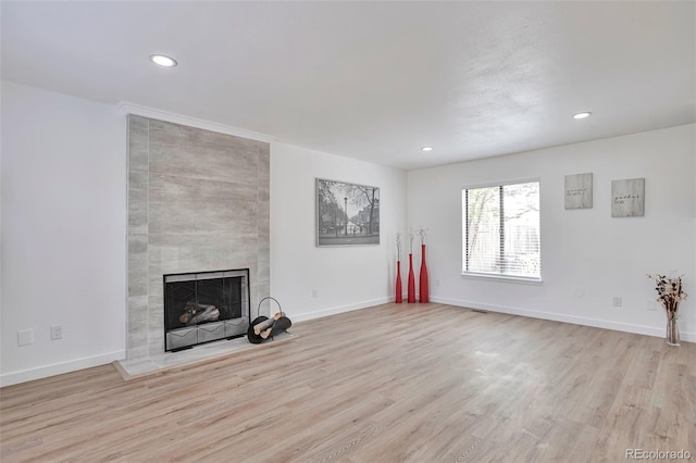 3575 S Ouray St, Aurora, CO 80013 - unfurnished living room featuring a tile fireplace, wood finished floors, recessed lighting, and baseboards