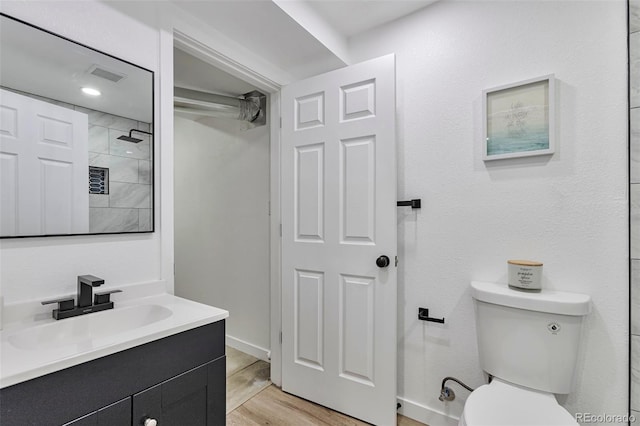3575 S Ouray St, Aurora, CO 80013 - full bath featuring vanity, toilet, wood finished floors, and a shower