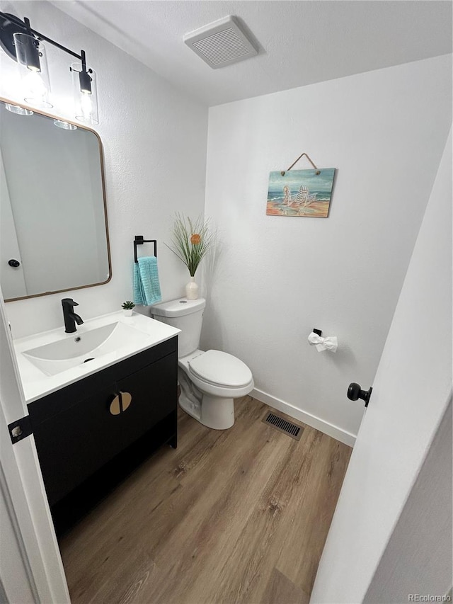 3575 S Ouray St, Aurora, CO 80013 - half bath with toilet, wood finished floors, vanity, and baseboards