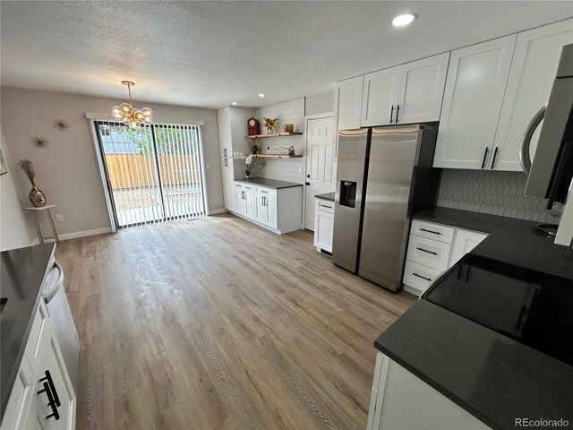 3575 S Ouray St, Aurora, CO 80013 - kitchen with stainless steel refrigerator with ice dispenser, dark countertops, decorative backsplash, open shelves, and recessed lighting