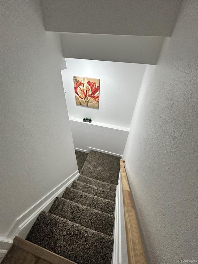 3575 S Ouray St, Aurora, CO 80013 - staircase featuring a textured wall and baseboards