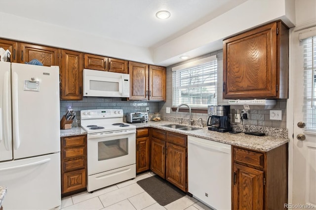 2437 E Geddes Pl, Centennial, CO 80122 - kitchen featuring white appliances, a sink, decorative backsplash, and brown cabinets