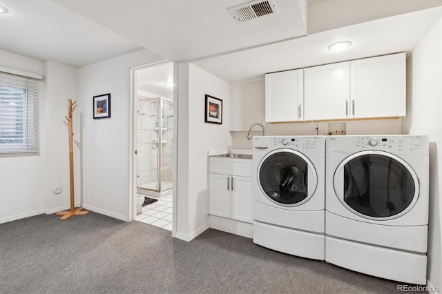 2437 E Geddes Pl, Centennial, CO 80122 - laundry area featuring washer and dryer, cabinet space, dark carpet, and baseboards
