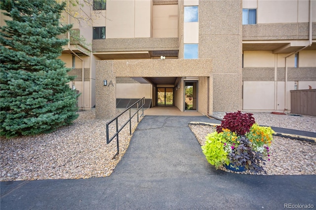 property entrance with stucco siding