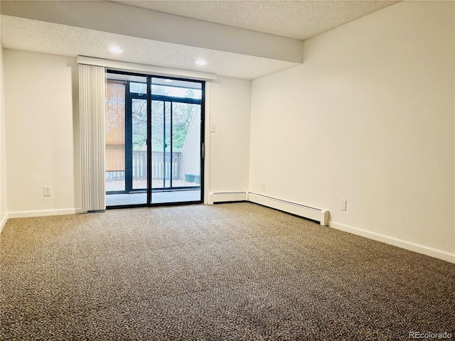 carpeted spare room featuring a textured ceiling