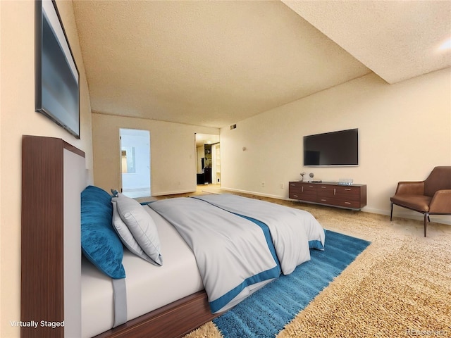 carpeted bedroom featuring visible vents, a textured ceiling, and baseboards