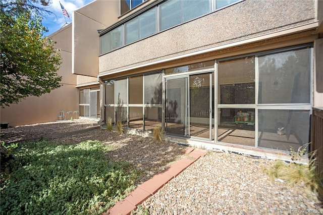 back of house featuring stucco siding