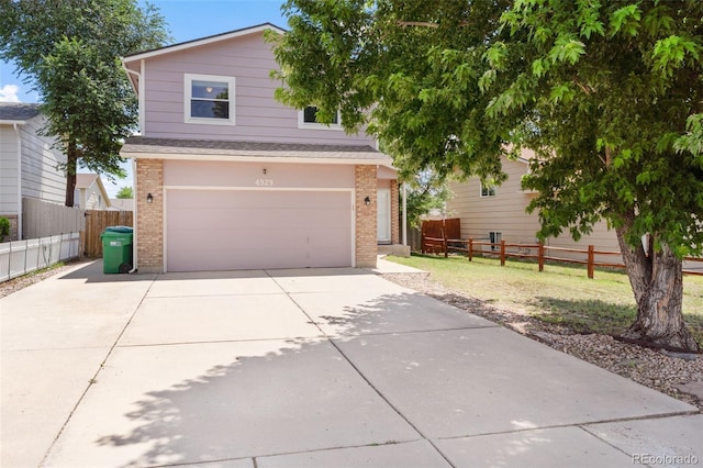 4929 Witches Hollow Ln, Colorado Springs, CO 80911 - traditional-style house with brick siding, concrete driveway, a garage, and roof with shingles